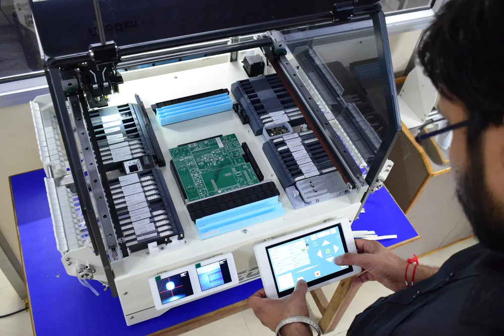 Engineer loading a board into the pick-and-place machine