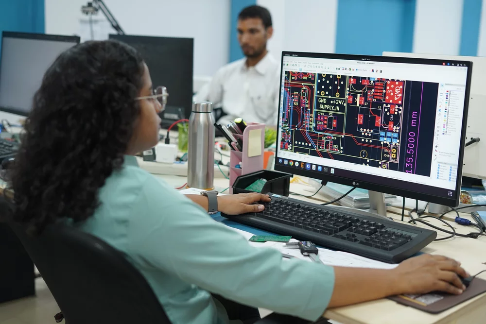 Engineer reviewing a PCB layout in EDA software